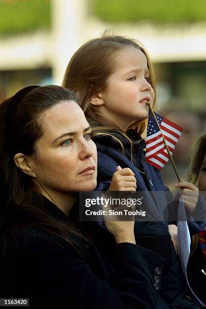 Actress and photographer Koo Stark holds her daughter aloft during a memorial service for victims of the World Trade Center catastrophe September 14,...