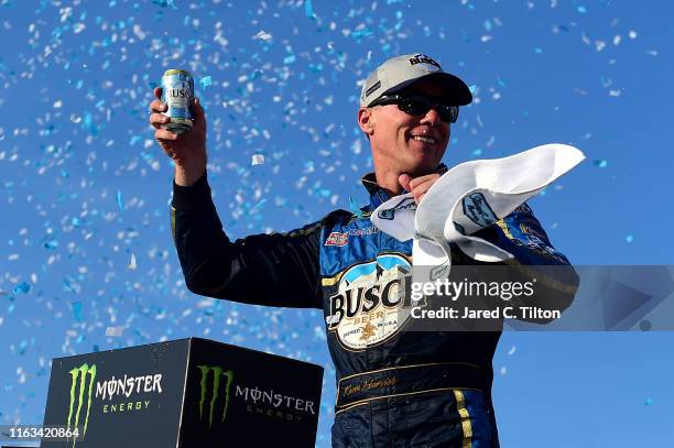 Kevin Harvick, driver of the Busch Beer/National Forest Foundation Ford, celebrates in Victory Lane after winning the Monster Energy NASCAR Cup...