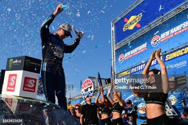 Kevin Harvick, driver of the Busch Beer/National Forest Foundation Ford, celebrates in Victory Lane after winning the Monster Energy NASCAR Cup...