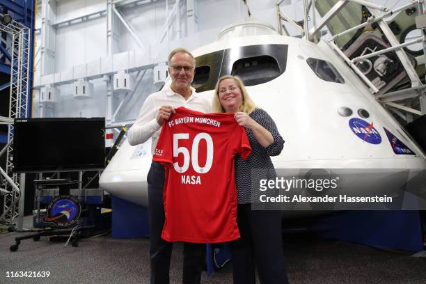 Karl-Heinz Rummenigge, CEO of FC Bayern Muenchen hands over a FC Bayern Muenchen jersey to Donna Shafer, JSC Associate Director at the Space vehicle...
