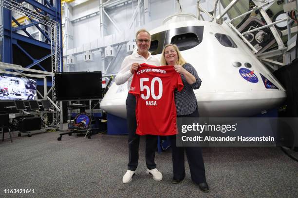 Karl-Heinz Rummenigge, CEO of FC Bayern Muenchen hands over a FC Bayern Muenchen jersey to Donna Shafer, JSC Associate Director at the Space vehicle...