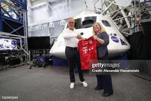 Karl-Heinz Rummenigge, CEO of FC Bayern Muenchen hands over a FC Bayern Muenchen jersey to Donna Shafer, JSC Associate Director at the Space vehicle...