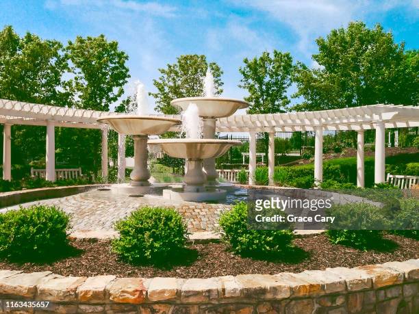 water flows from fountains in idyllic community - fredericksburg photos et images de collection