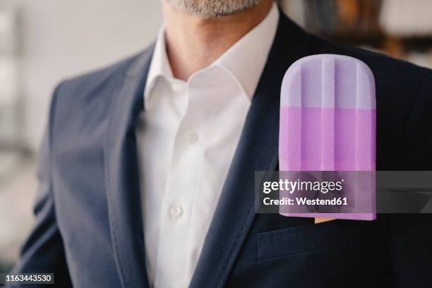 close-up of businessman with fake popsicle - extreme close up stock-fotos und bilder