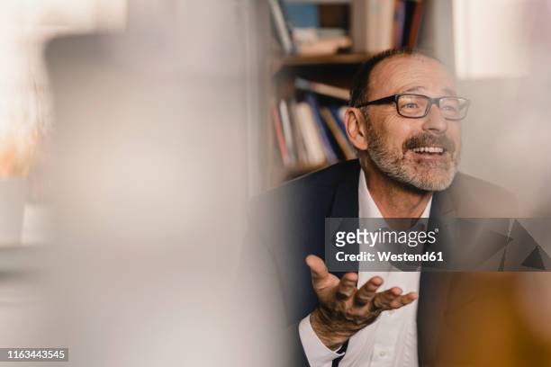 mature businessman talking in a cafe - selective focus stock-fotos und bilder