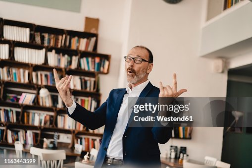 Exuberant mature businessman in a cafe Exuberant mature businessman in a cafe