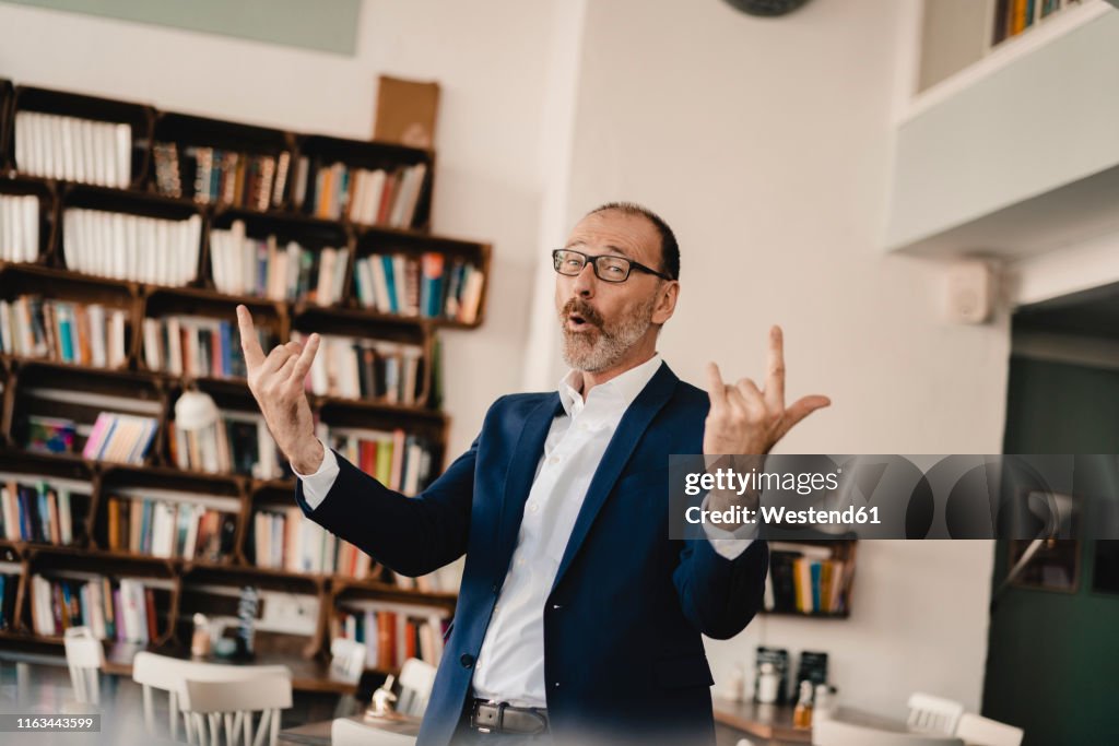 Exuberant mature businessman in a cafe