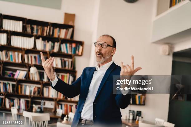 exuberant mature businessman in a cafe - histeria imagens e fotografias de stock