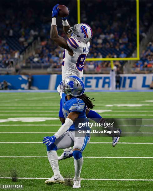 Duke Williams of the Buffalo Bills makes a leaping catch over Andre Chachere of the Detroit Lions in the second half and scores a touchdown during a...