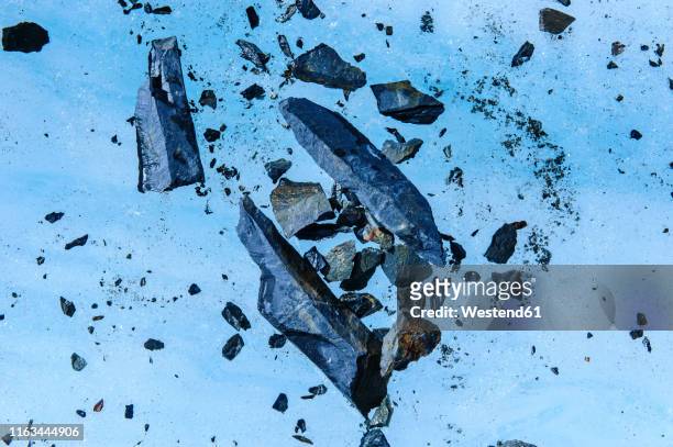 stones frozen in the blue ice of fox glacier, south island, new zealand - westland stock-fotos und bilder