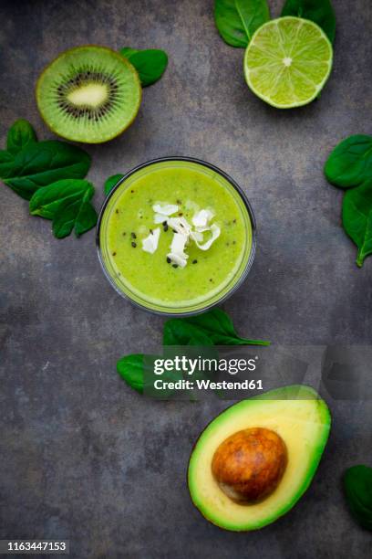 green smoothie with avocado, spinach, kiwi and lime, coconut flakes and black sesame - avocado smoothie stock pictures, royalty-free photos & images