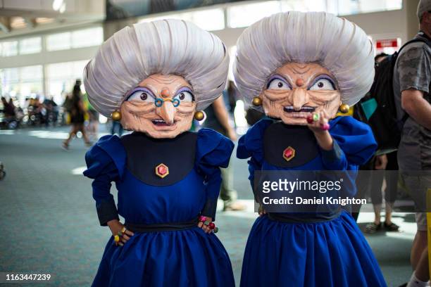 Cosplayers Chieko as Zeniba and Chihiro as Yubaba from "Spirit In The Wind" pose at 2019 Comic-Con International on July 21, 2019 in San Diego,...
