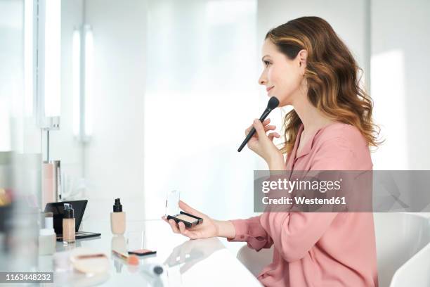 woman applying make up at home - pink vanity stock pictures, royalty-free photos & images