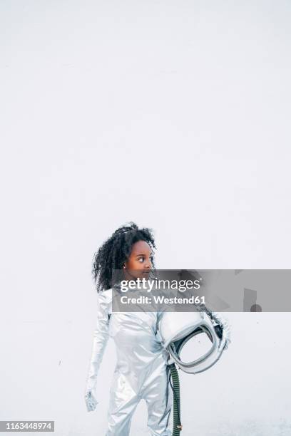 little girl wearing space suit in front of white background looking around - child in space suit stock pictures, royalty-free photos & images