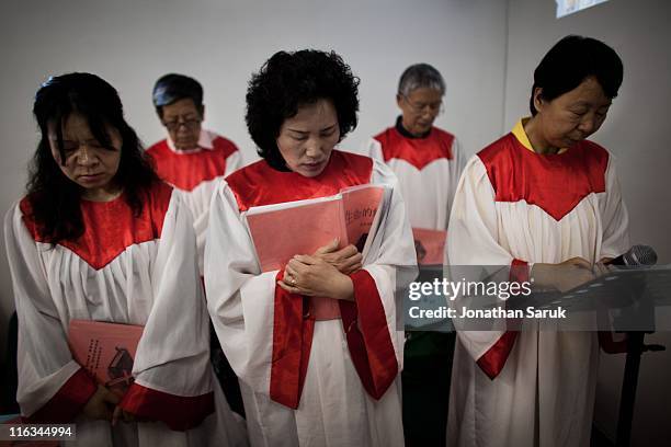 Members of the house church Xin Mingling meet for Sunday service May 15, 2011 in Beijing, China. House churches, which operate in a legal grey area,...