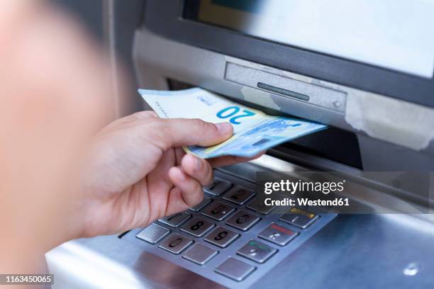close up of businesswoman withdraw money on a cash machine - twenty euro note stock pictures, royalty-free photos & images