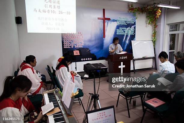 Members of the house church Xin Mingling meet for Sunday service May 15, 2011 in Beijing, China. House churches, which operate in a legal grey area,...