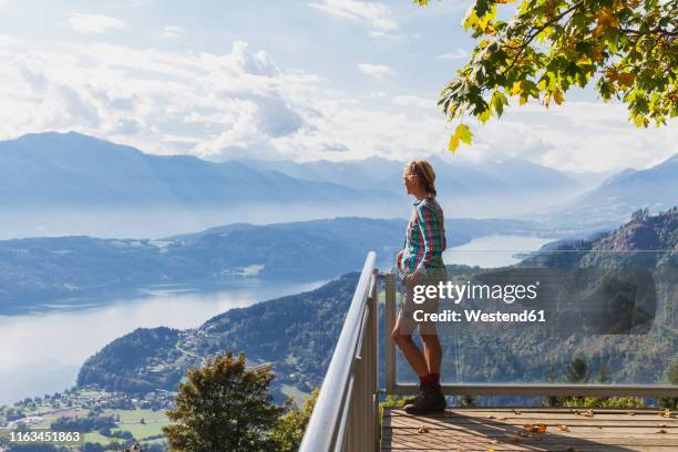 woman standing on observation point above millstatt lake, carinthia, austria - carinthia 個照片及圖片檔