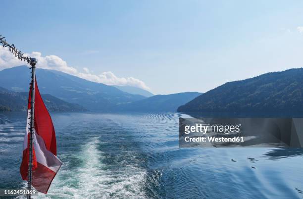austrian flag on a boat, millstatt lake, carinthia, austria - austria flag stock-fotos und bilder