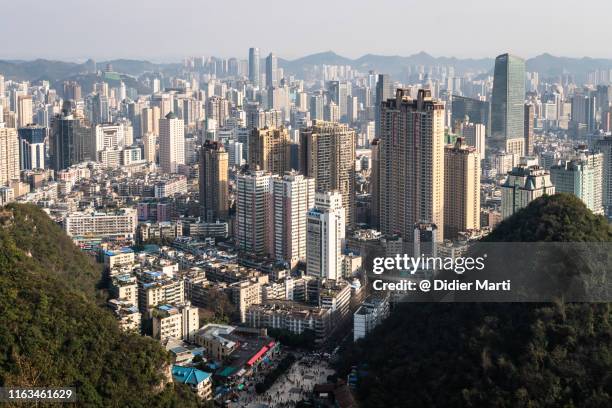 guiyang cityscape from the top of the qianlingshan park in quizhou provincial capital city - newly industrialized country stock pictures, royalty-free photos & images