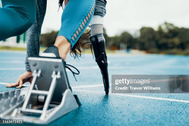 female adaptive athlete training for competition at a university athletics stadium - disabled runner stock pictures, royalty-free photos & images