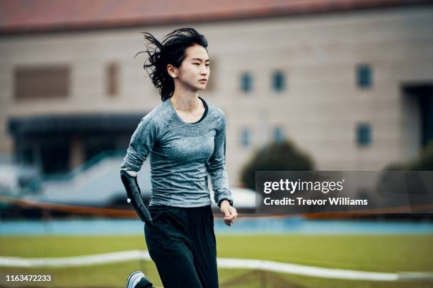 female adaptive athlete training at a running track - sports training ストックフォトと画像