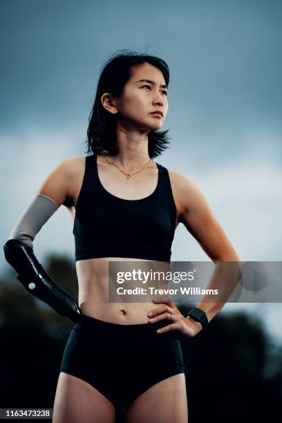 portrait of a female adaptive athlete at an athletics stadium - japanese ethnicity the human body stock pictures, royalty-free photos & images