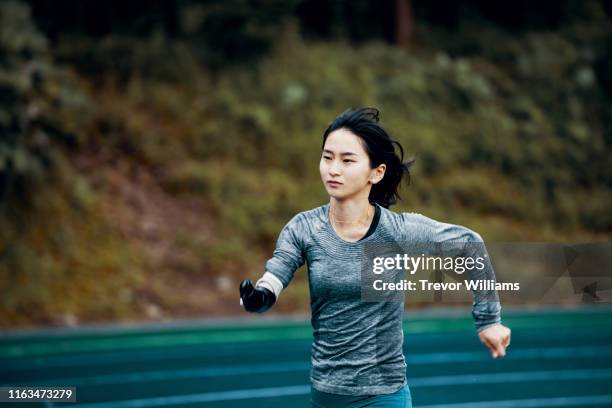 Female adaptive athlete training at a running track