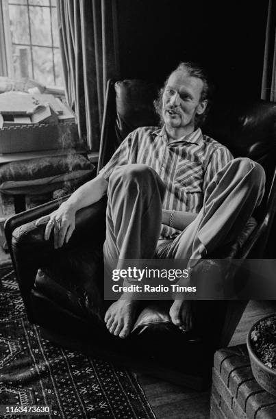 Drummer Ginger Baker relaxing in front of a large bay window, June 1973.