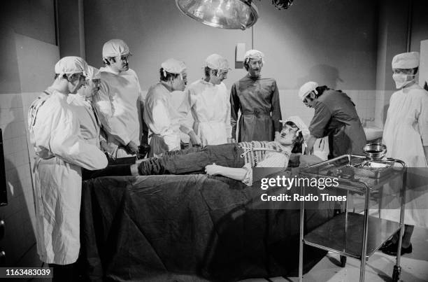 Comedians John Cleese, Terry Gilliam, Eric Idle, Graham Chapman, Terry Jones, Carol Cleveland and Michael Palin in the 'Gumby Brain Surgery' sketch...