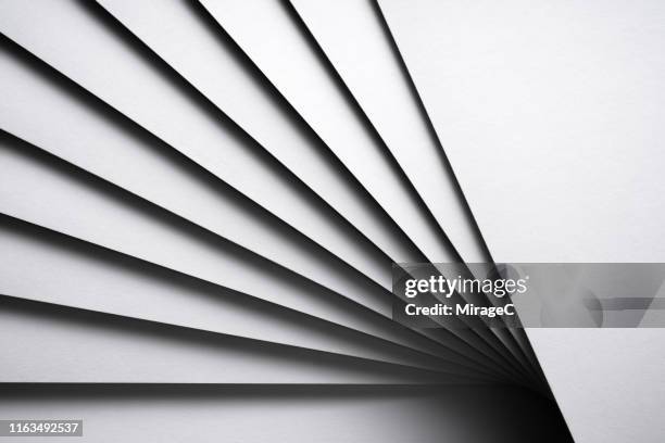 monochrome white stacking paper fanned out - aufgefächert stock-fotos und bilder