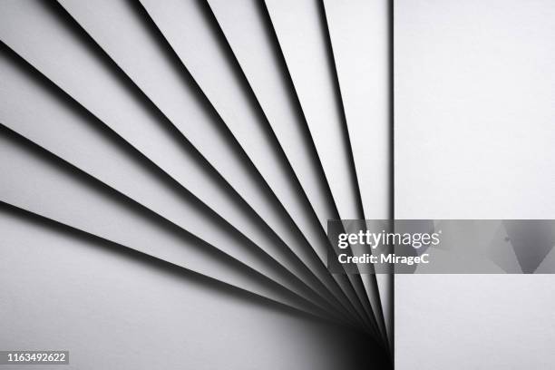 monochrome white stacking paper fanned out - aufgefächert stock-fotos und bilder