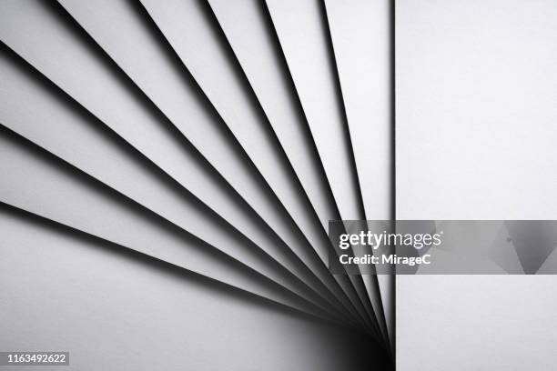 monochrome white stacking paper fanned out - abrir en abanico fotografías e imágenes de stock