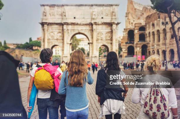 family of three generations, grandmother, father and daughters walking around rome - stadium or arena or coliseum or colosseum or ring exterior or outdoor stock-fotos und bilder