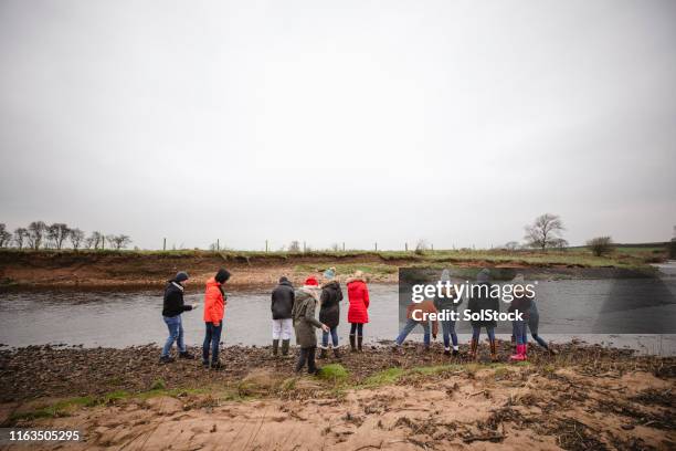 friends skimming stones - skimming stones stock pictures, royalty-free photos & images