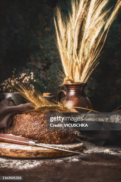 homemade rye bread on rustic table - rye grain stock-fotos und bilder