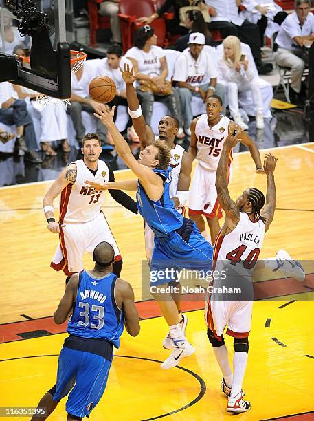 Dirk Nowitzki of the Dallas Mavericks goes to the basket over Chris Bosh of the Miami Heat during Game One of the 2011 NBA Finals on May 31, 2011 at...