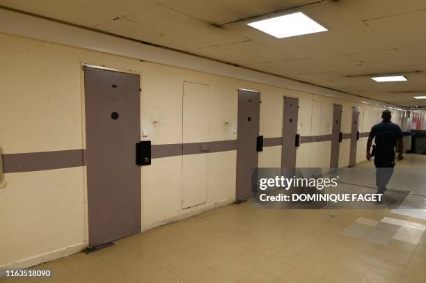 Prison guard walks in a corridor at the Poissy prison, specialised in long sentences, August 14 in Poissy, west of Paris. - Behind the high walls of...