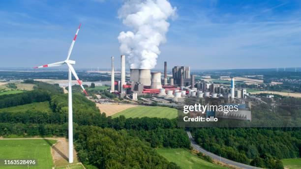 wind turbine and coal power station - industrial district stock pictures, royalty-free photos & images