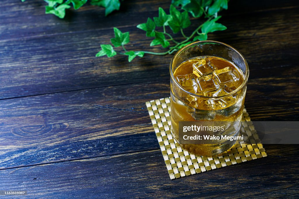 Japanese plum wine 'Umeshu' on wooden background