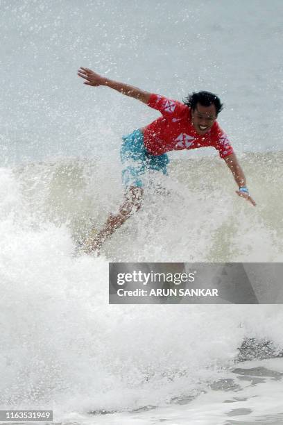 Participant surfs during the annual Covelong Point Classic Surf festival at Kovalam on the outskirts of Chennai on August 24, 2019.