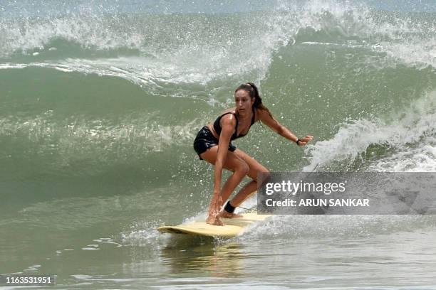 Participant surfs during the annual Covelong Point Classic Surf festival at Kovalam on the outskirts of Chennai on August 24, 2019.