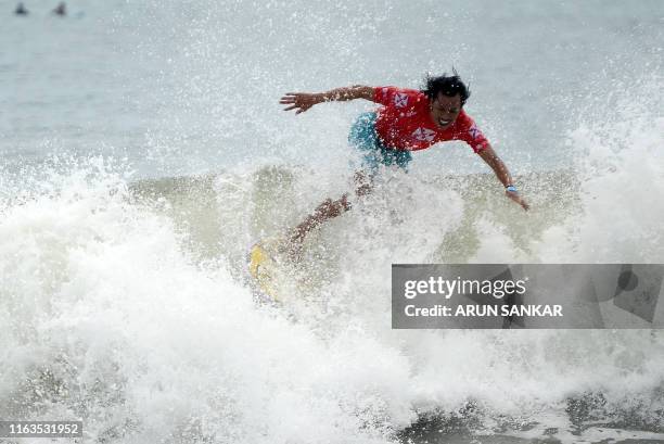 Participant surfs during the annual Covelong Point Classic Surf festival at Kovalam on the outskirts of Chennai on August 24, 2019.