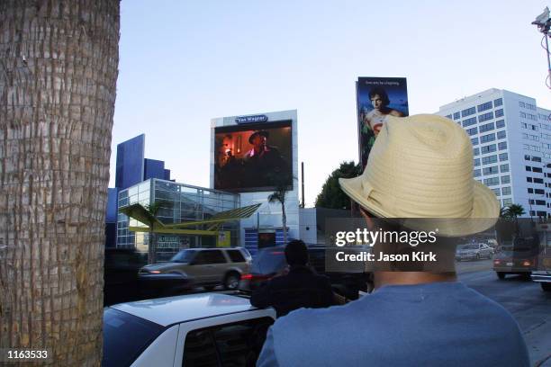 Man watches the big screen TV next door to the House Of Blues witch is displaying Michael Jackson's new short film "You Rock My World" starring...