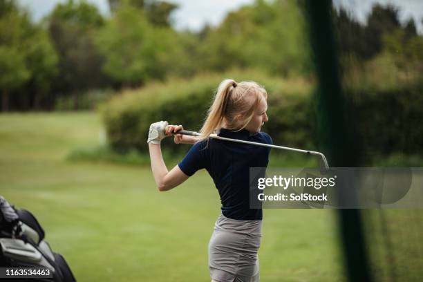 full swing at the golf course - kids athletics stock pictures, royalty-free photos & images