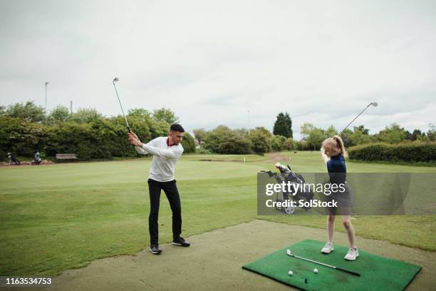 golfers improving their swing - practice drill stock pictures, royalty-free photos & images