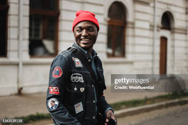 Young black South African man wearing a suit and hat outdoors