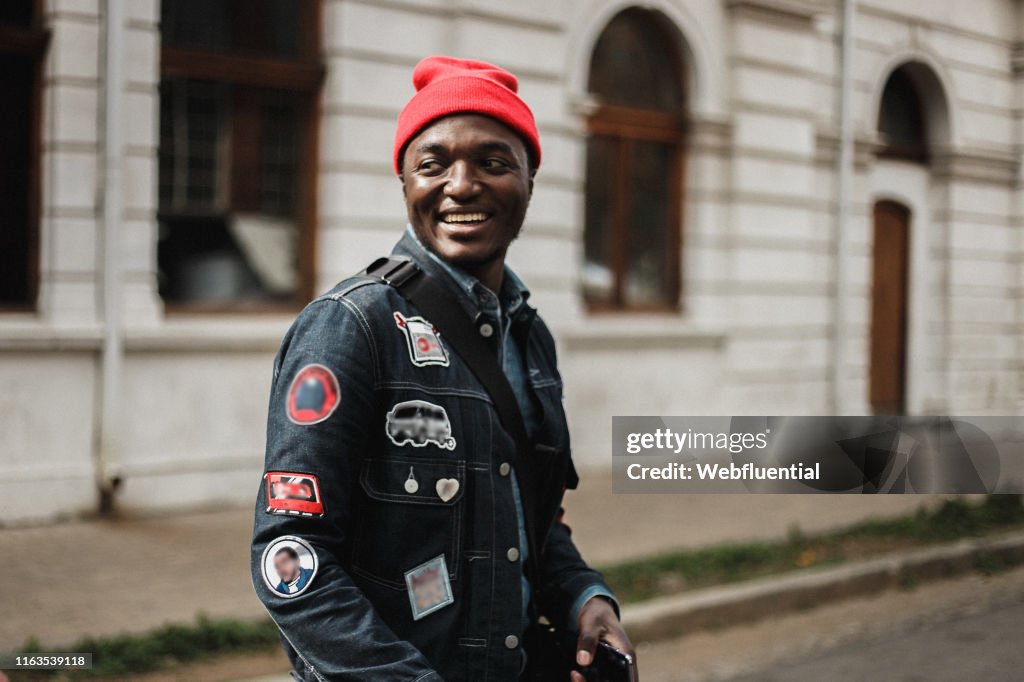Young black South African man wearing a suit and hat outdoors
