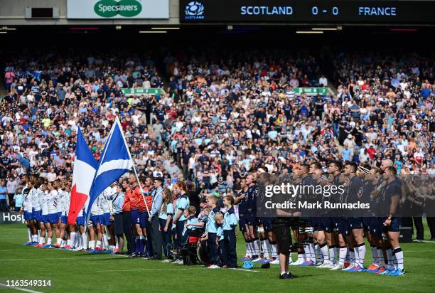 The Scotland and France teams stand for the National Anthem crowd during the Summer Test match between Scotland and France at Murrayfield Stadium on...