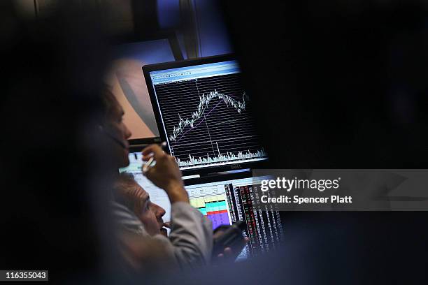 Traders work on the floor of the New York Stock Exchange before the close on June 15, 2011 in New York City. Reversing much of the previous day's...